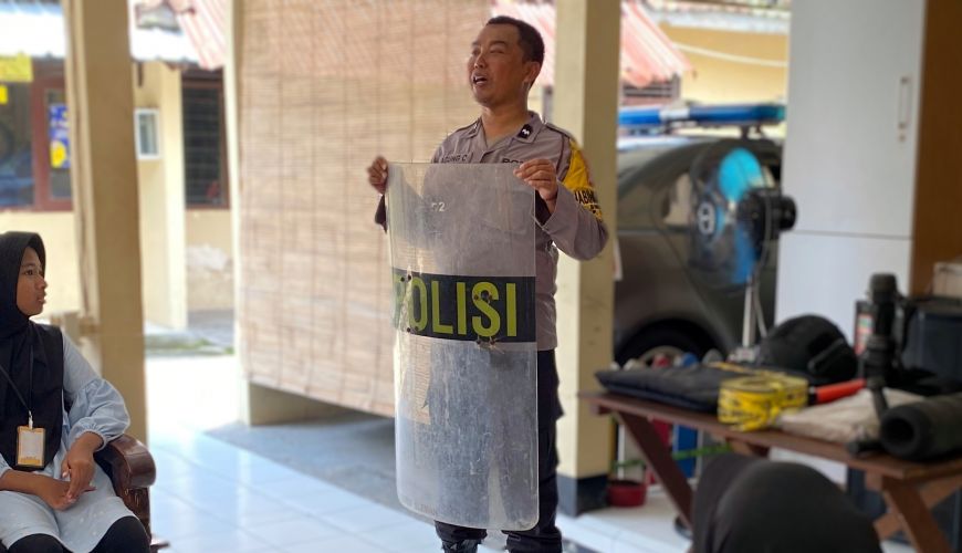 Mendengar penjelasan tentang berbagai peralatan kerja polisi. (Dok. Yayasan Literasi Desa Tumbuh)